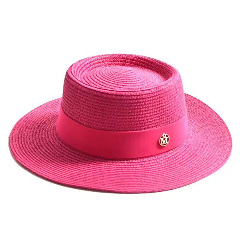 Pink straw hat with a band on a white background