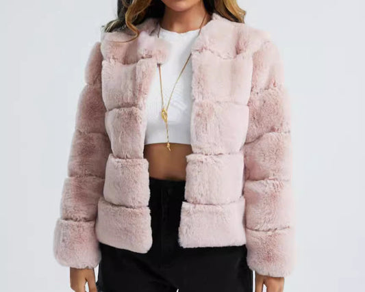 Woman wearing a pink faux fur jacket on a white background