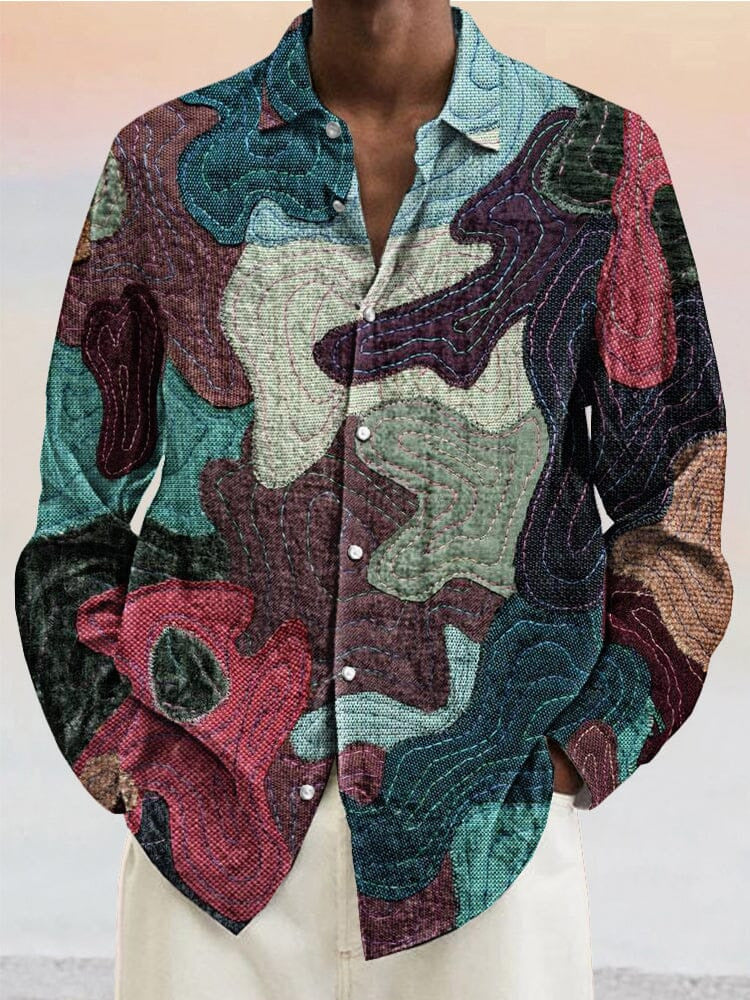 A men's casual beach shirt with a multicolored, abstract paint splatter design.