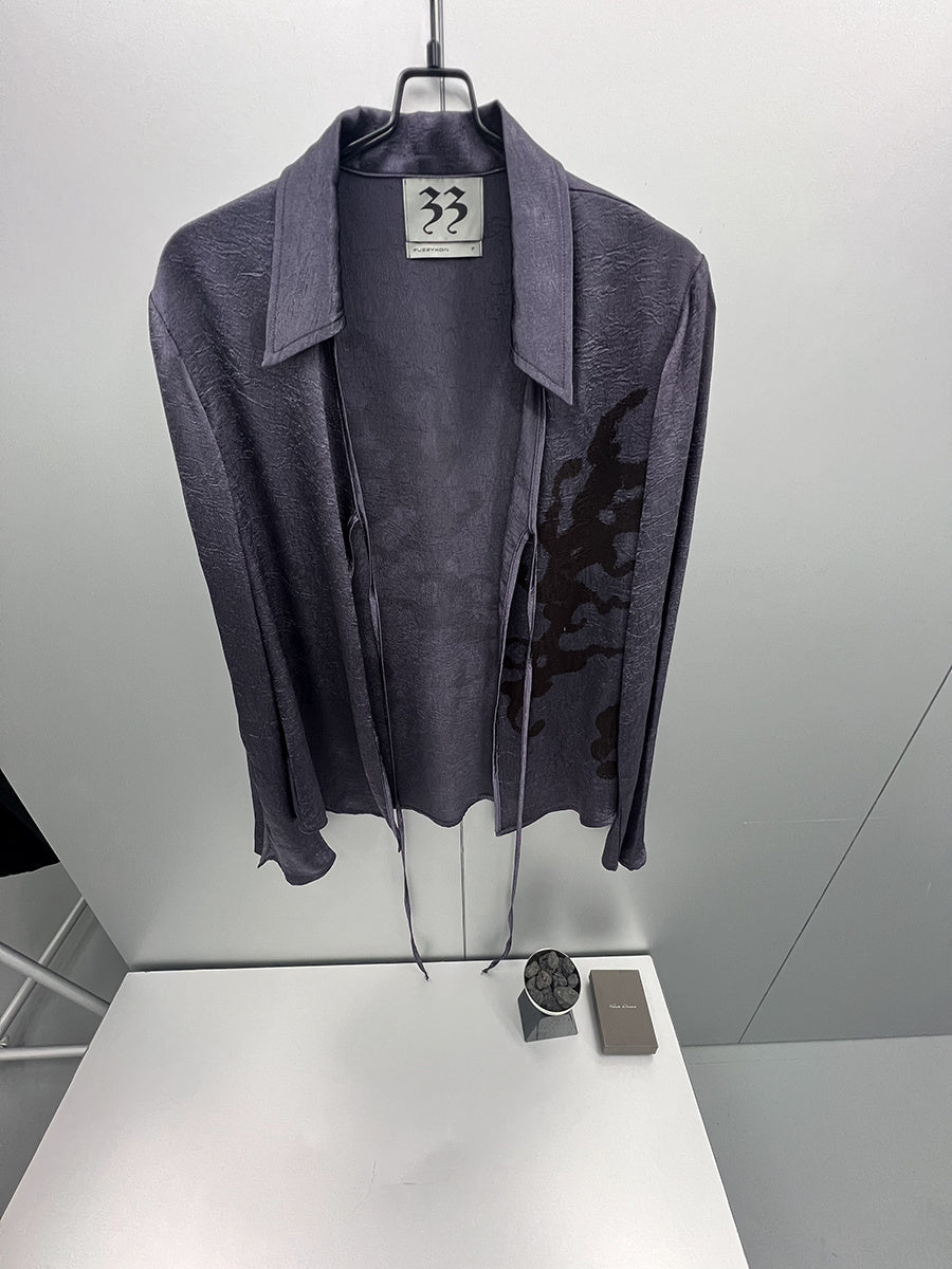 Dark gray jacket on a hanger with a visible brand label against a white background
