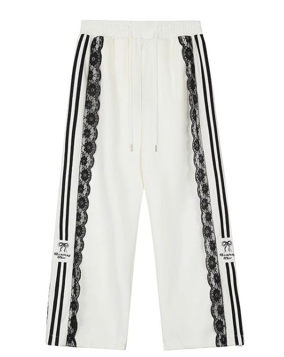 White pants with black stripes and lace details on a white background