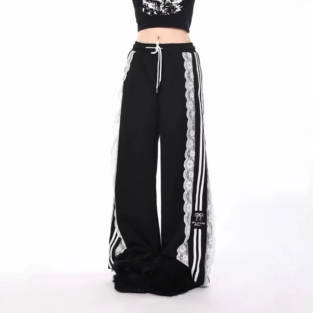 Black pants with white lace trim and stripes on a white background