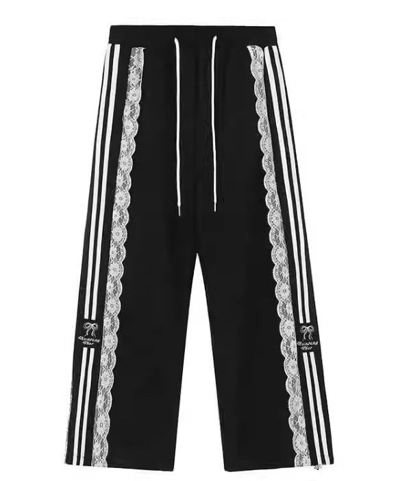 Black pants with lace trim and white stripes on a white background
