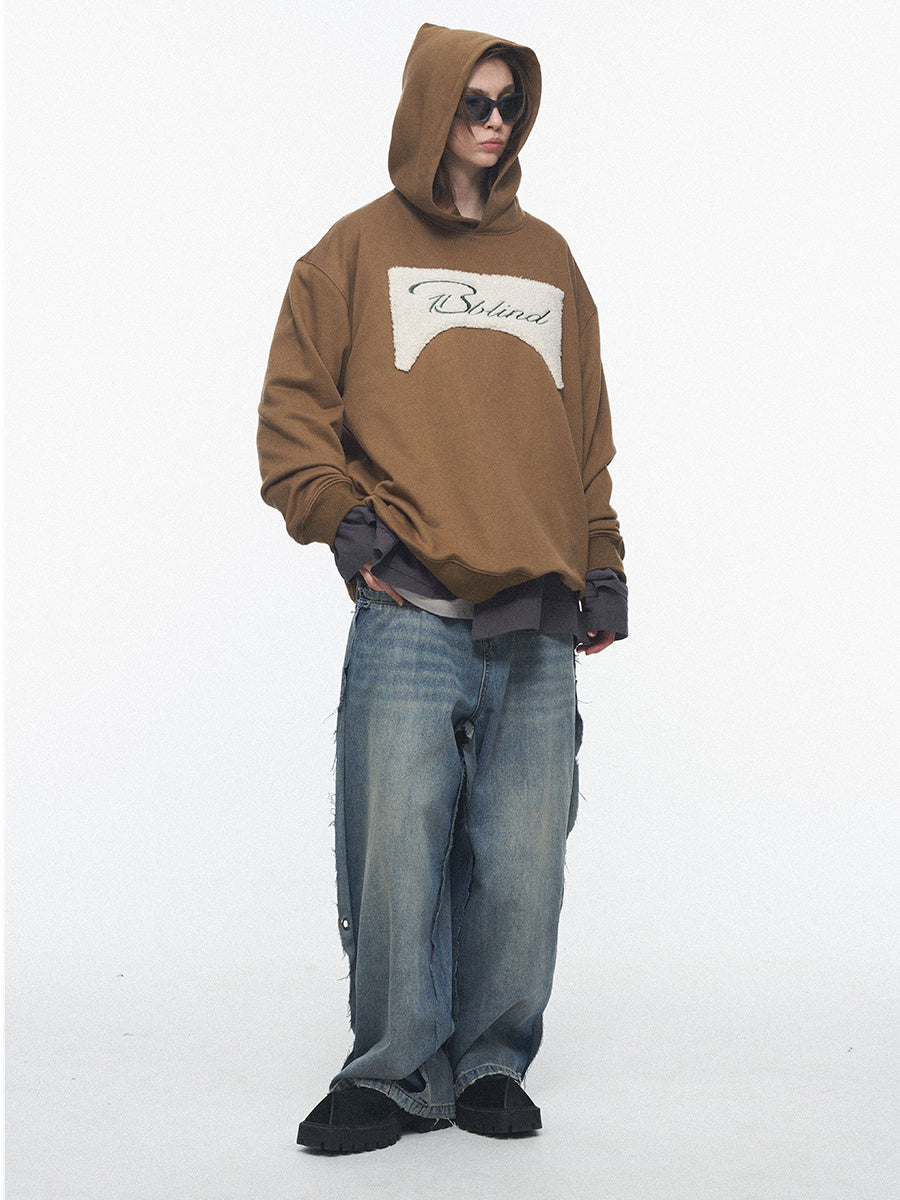 Person wearing a brown hoodie with a logo on a white background