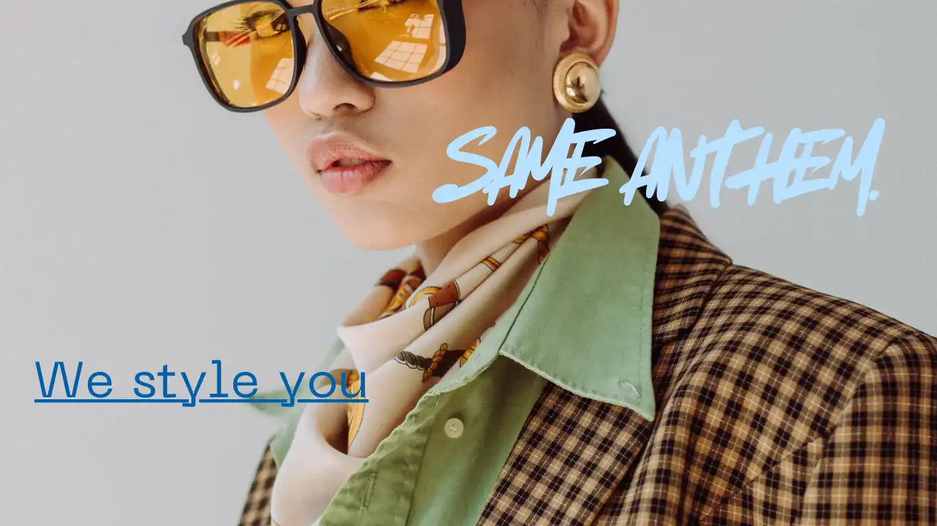 Stylish model in sunglasses and a plaid blazer