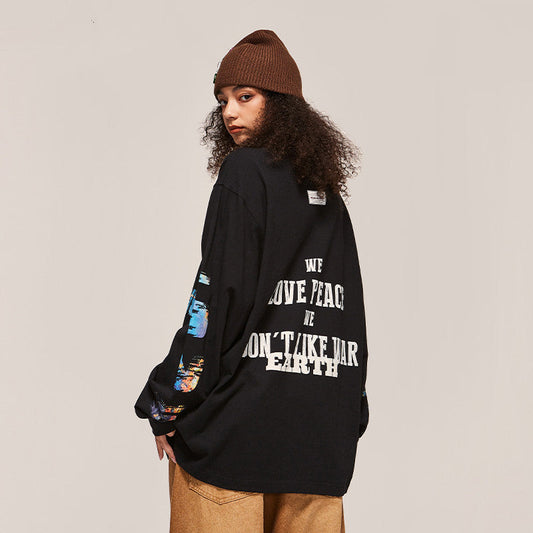 Person wearing a black oversized sweatshirt with text on the back, standing against a plain background