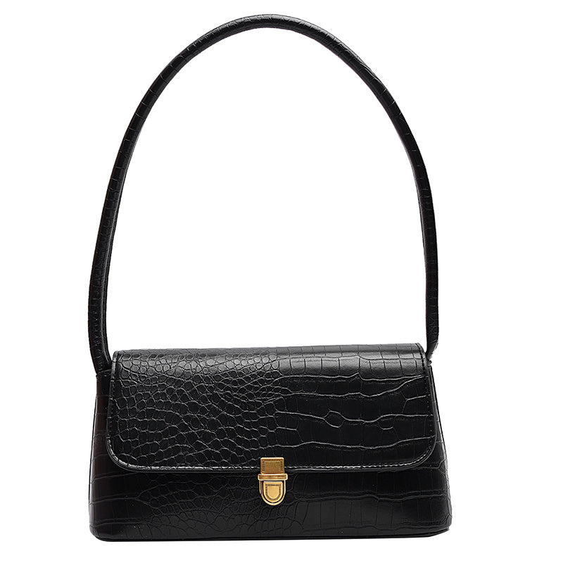 Black handbag with a gold clasp on a white background
