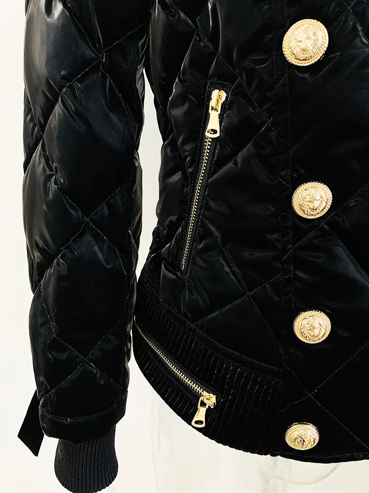 Black quilted jacket with gold buttons and zippers on a white background