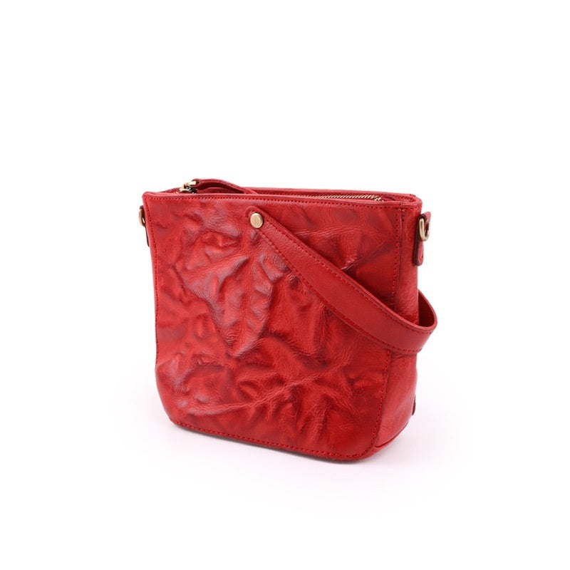 Red textured handbag on a white background
