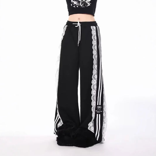 Black pants with white lace trim and stripes on a white background
