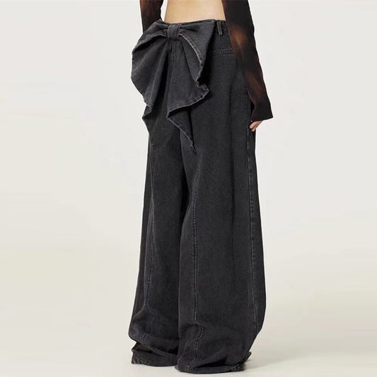 Black wide-leg pants with a bow detail on a white background
