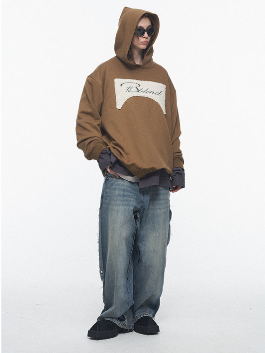 Person wearing a brown hoodie with a logo on a white background