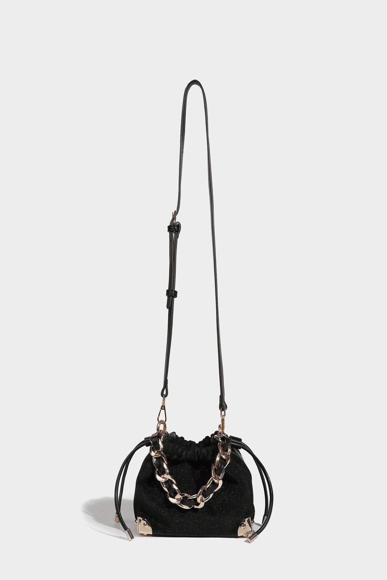 Black drawstring bag with gold chain detail on a white background