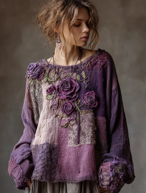 Woman wearing a purple floral embroidered blouse against a neutral background