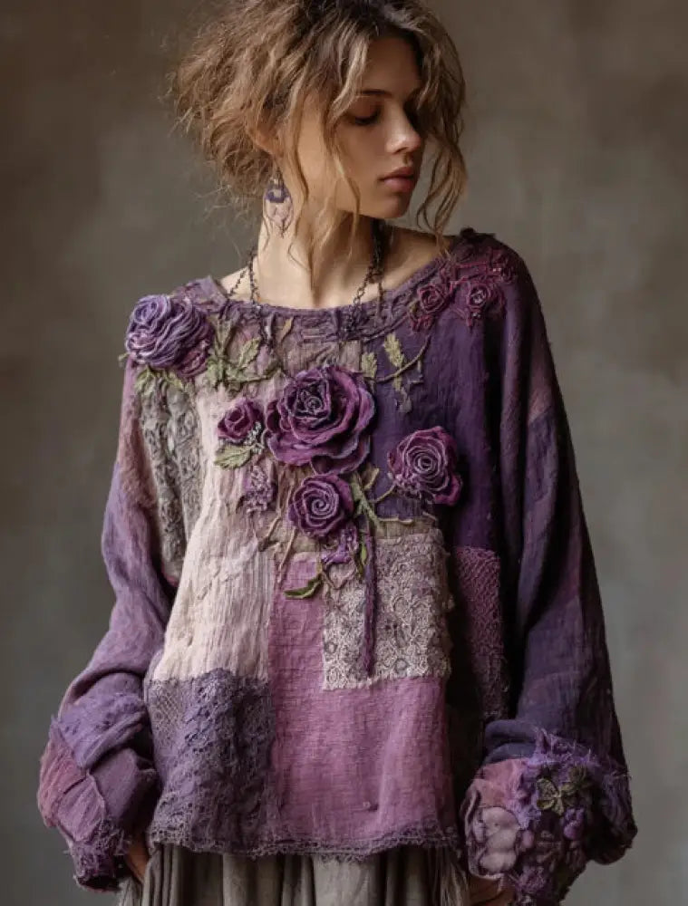 Woman wearing a purple floral embroidered blouse against a neutral background