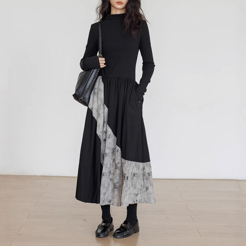 Person wearing a black and gray dress with a white background