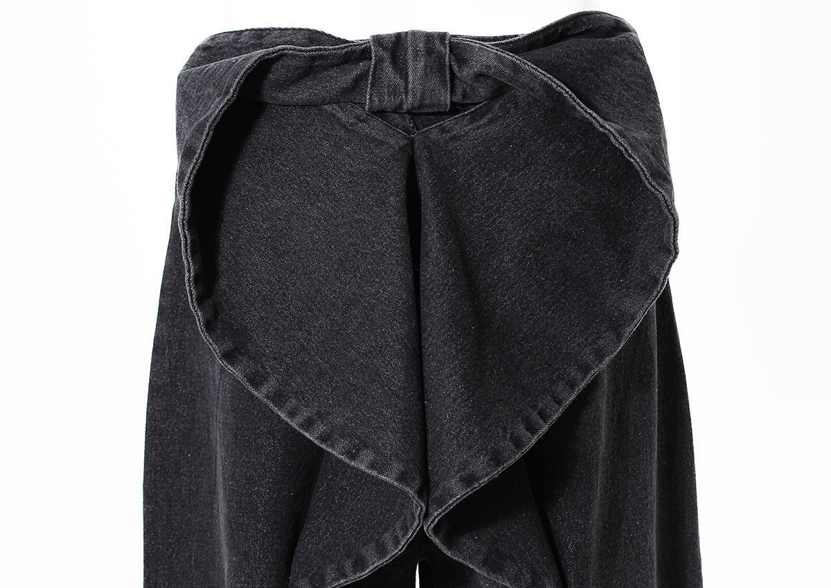 Black denim skirt with a bow detail on a white background