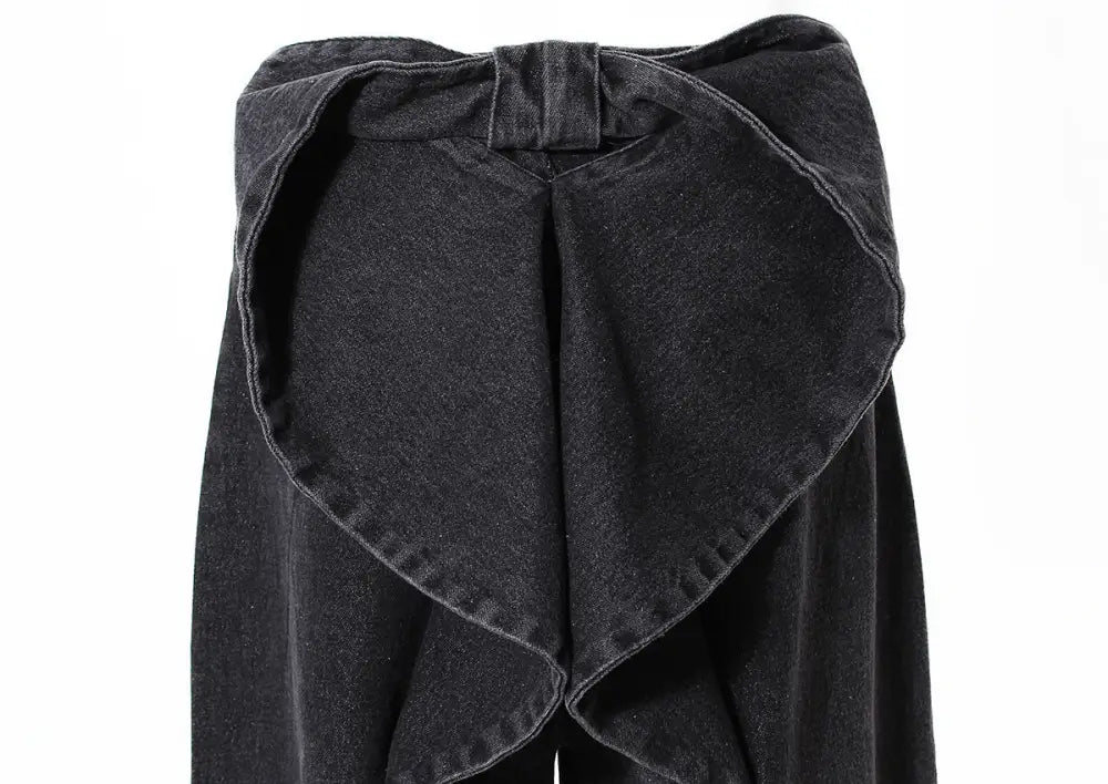 Black denim skirt with a bow detail on a white background