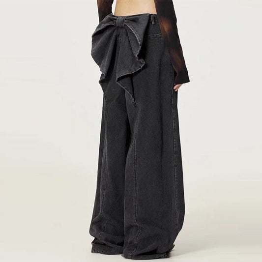 Black wide-leg pants with a bow detail on a white background