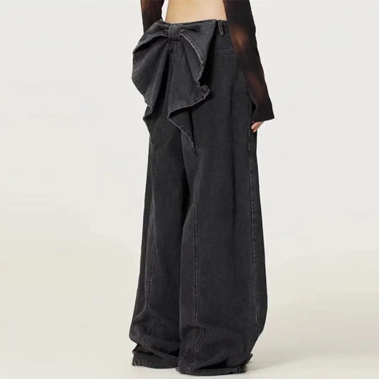 Black wide-leg pants with a bow detail on a white background