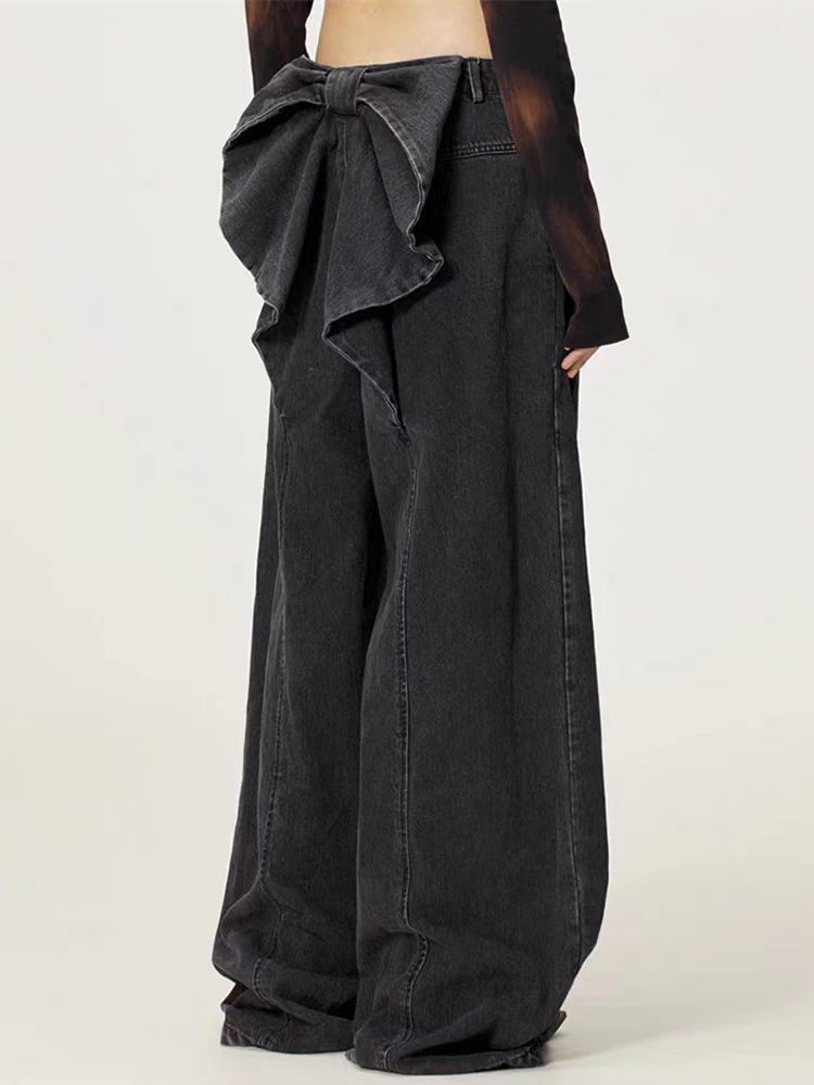 Black wide-leg pants with a large bow detail on a white background