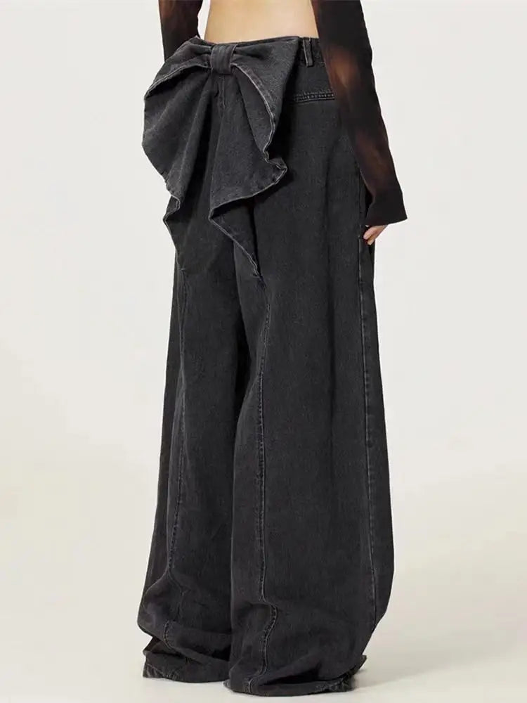 Black wide-leg pants with a large bow detail on a white background