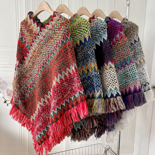 A collection of multicolored geometric patterned shawls displayed on hangers, with colors including pink, green, red, blue, yellow, purple, gray, and white.