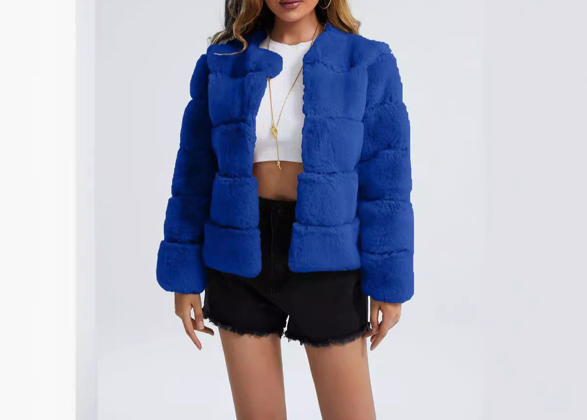 Woman wearing a blue puffer jacket on a white background