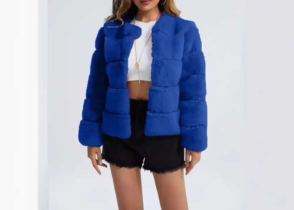 Woman wearing a blue puffer jacket on a white background