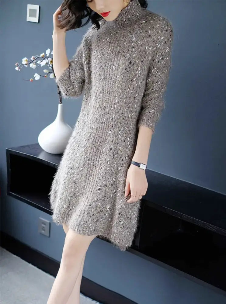 Woman wearing a sparkly dress in a room with a blue wall and white vase.