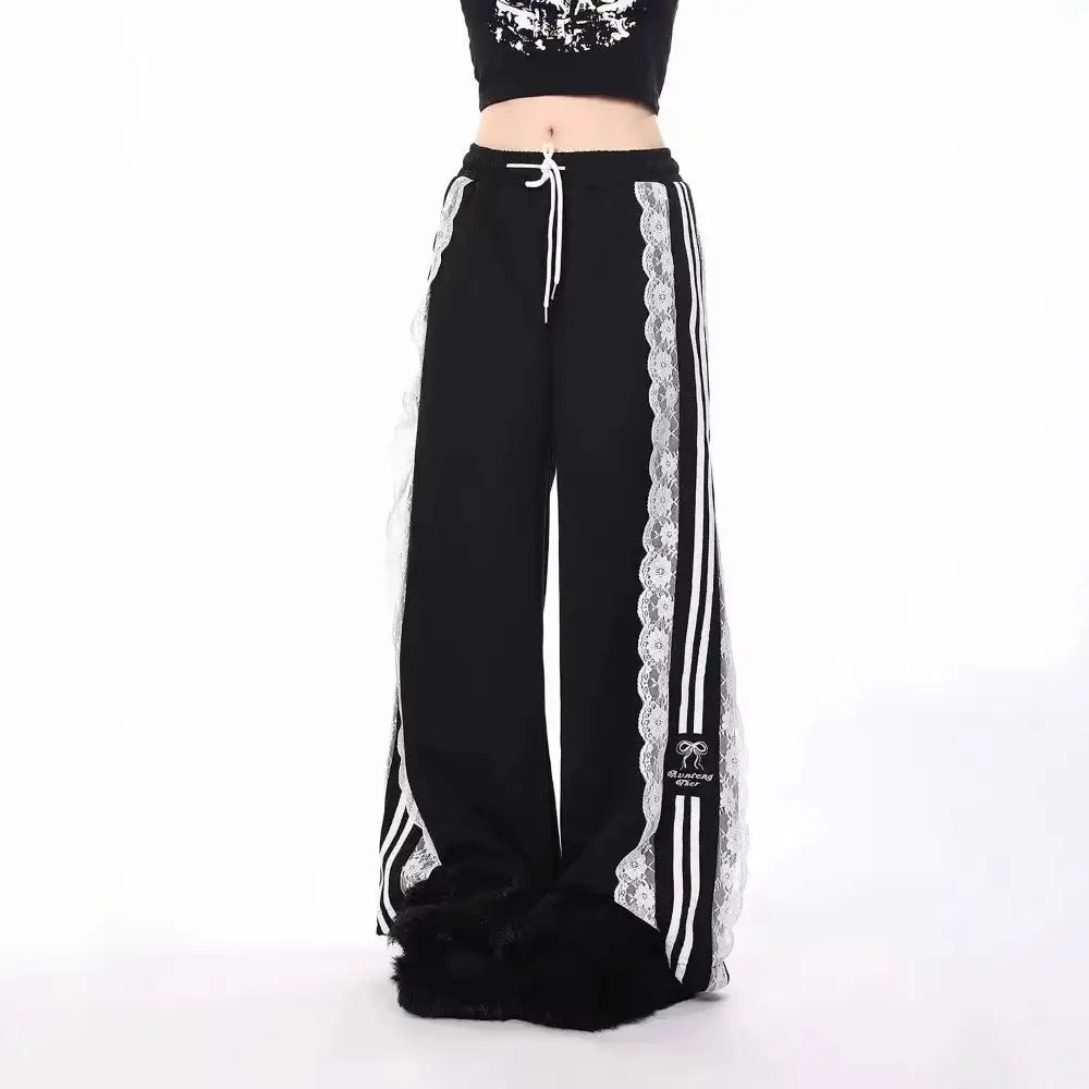 Black pants with white lace trim and stripes on a white background
