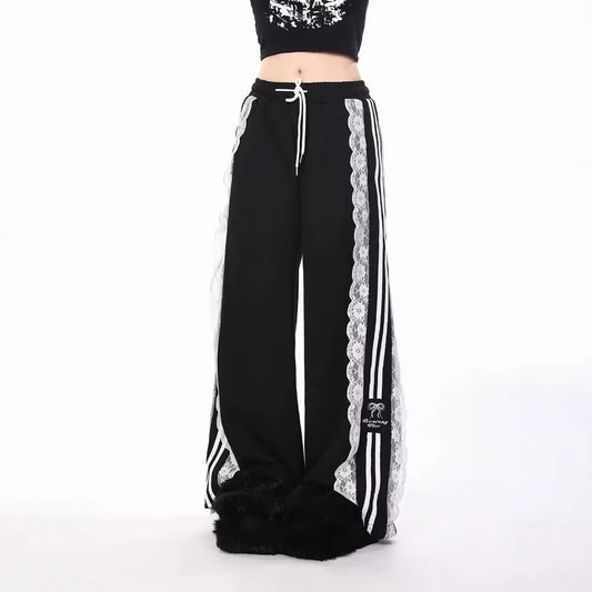 Black pants with white lace trim and stripes on a white background