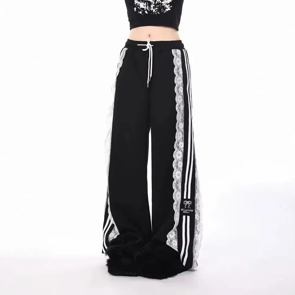 Black pants with white lace trim and stripes on a white background