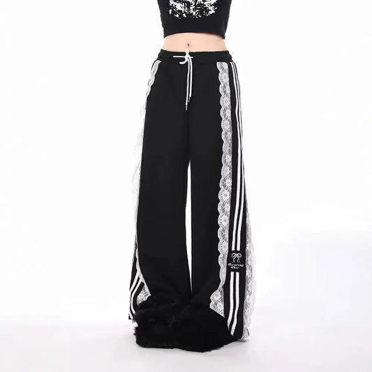 Black pants with white lace trim and stripes on a white background