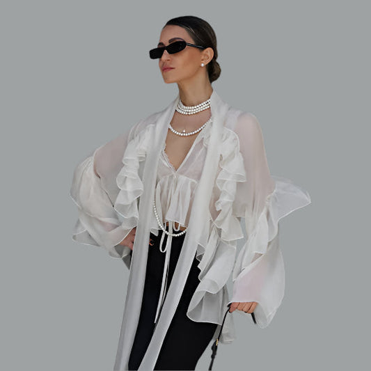 a woman wears a white laced meced ruffeled chiffon blouse