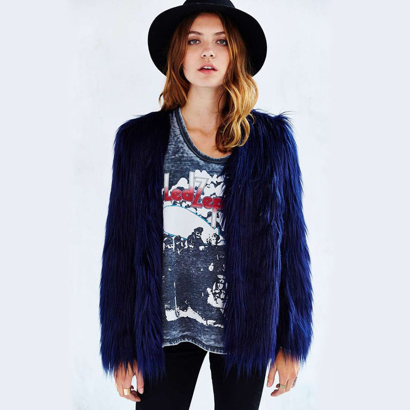Person wearing a blue fur coat over a graphic t-shirt on a white background