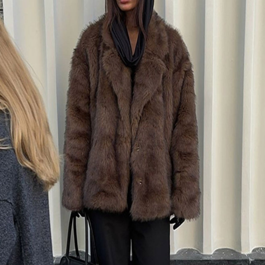 Brown fur coat worn by a person with a blurred background