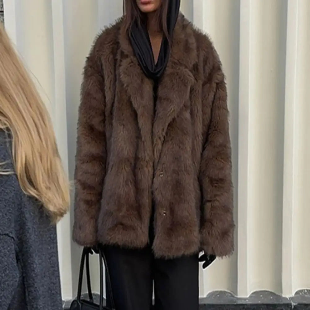 Brown fur coat worn by a person with a blurred background