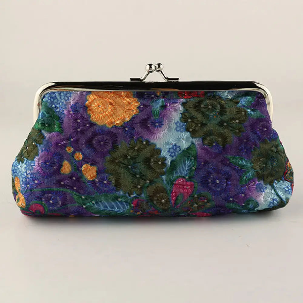 Colorful embroidered clutch bag on a light gray background