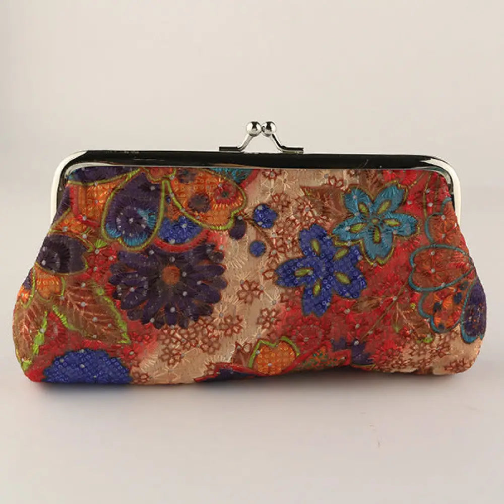 Colorful floral patterned clutch bag on a light gray background