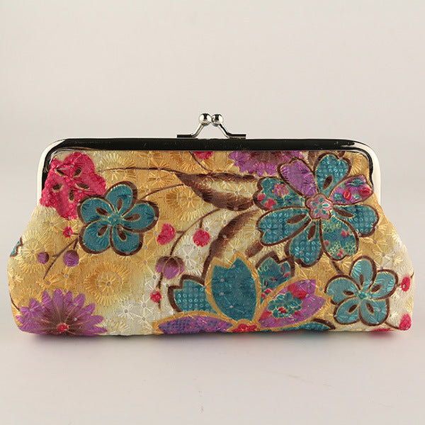 Floral patterned clutch bag on a beige background