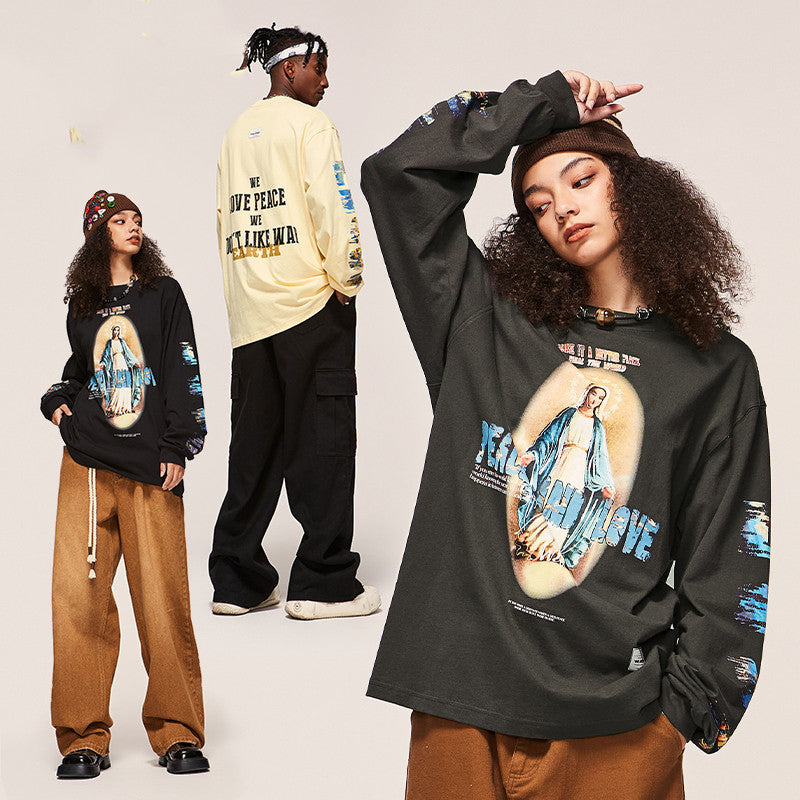 Three people wearing graphic sweatshirts with a central figure and text on a plain background