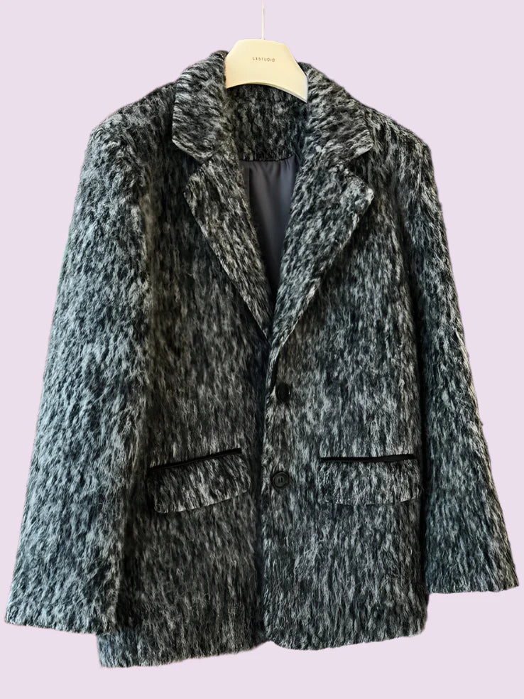 Textured gray coat on a hanger against a blurred background