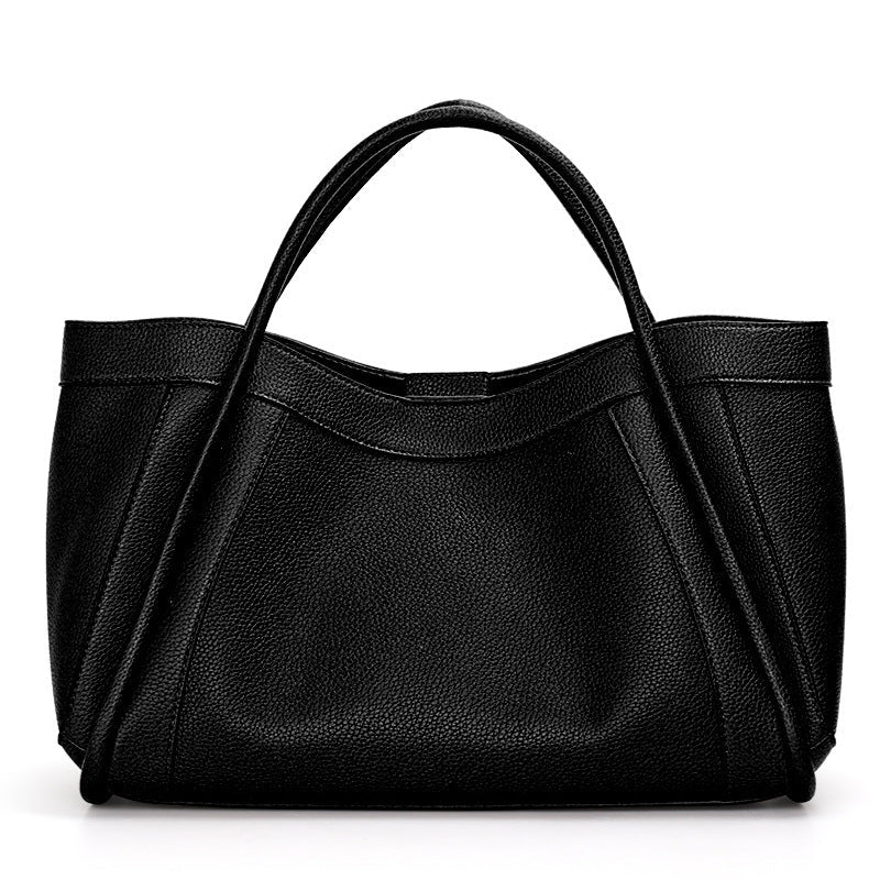 Black leather handbag on a white background