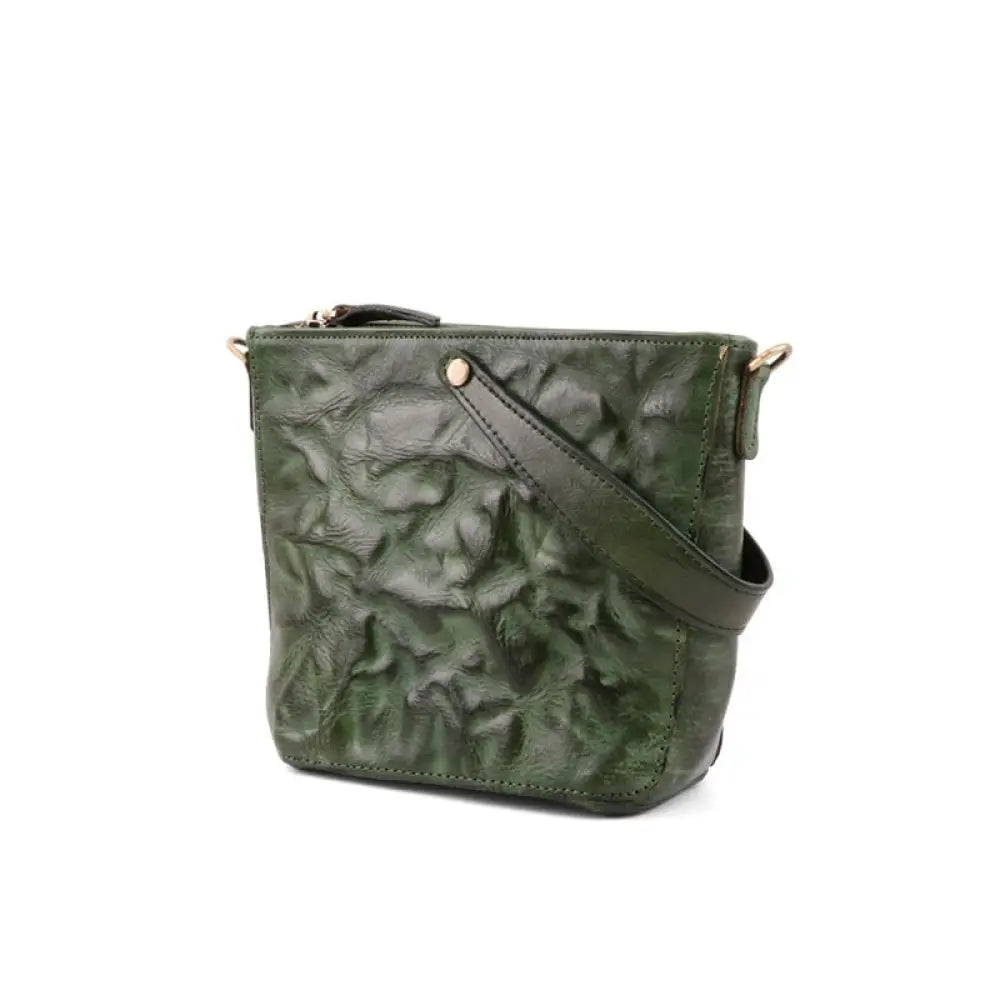 Green textured handbag with a strap on a white background