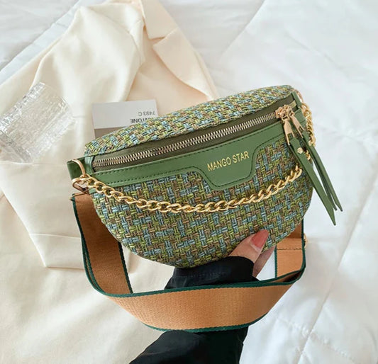 Green textured handbag with gold chain detail on a white surface